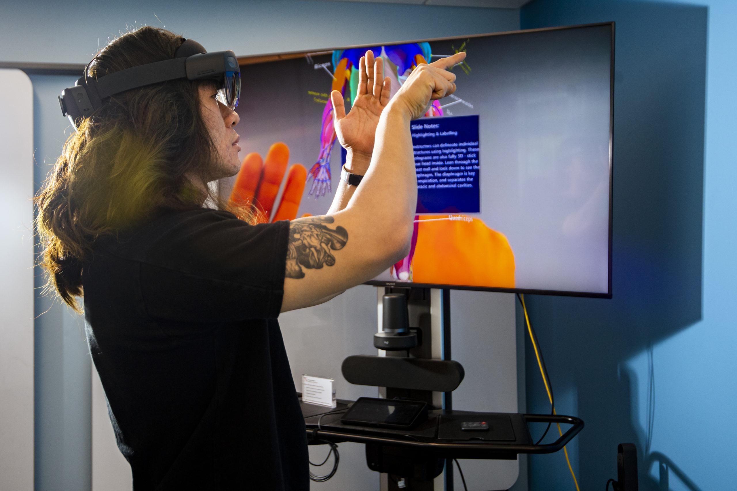 Student wearing VR goggles in the Human Data Interaction Lab at the Roux Institute at Northeastern University in Portland, Maine